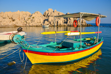 Colorful Greek fishing boat on coast of Rhodes island, Greece