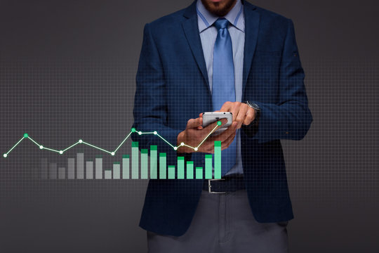 Businessman with growing chart, economy going up