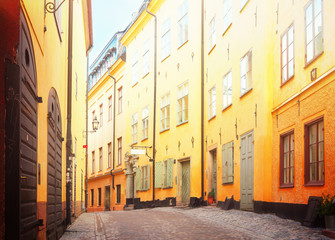 Fototapeta na wymiar view of old town street in Stockholm at sunny day, Sweden, retro toned
