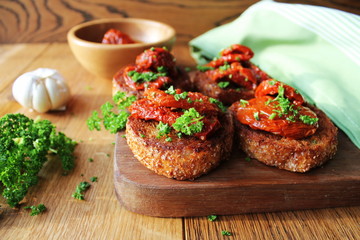 Appetizer- bruschetta with olive oil, sun-dried tomatoes and parsley