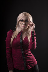 Lovely blonde woman wearing glasses and dressed in red blouse