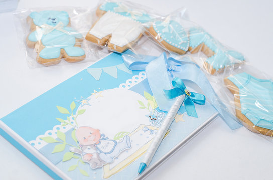 Photo book for a newborn, cookies and pencil on a white background