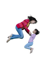 Mother and child leaping in studio