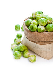 Fresh  brussels sprouts in sackcloth bag isolated on white backg