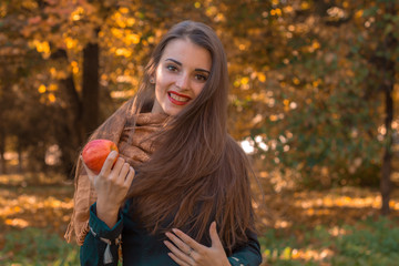 Fototapeta na wymiar beautiful girl smiling and holding a Red Apple in hand