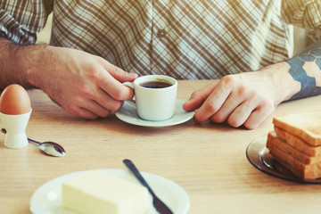 male hands with morning coffee having healthy breakfast