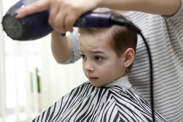Boy in hairdresser salon