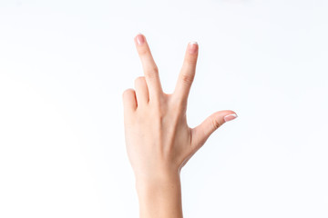 female hand showing the gesture with three fingers