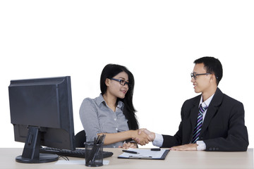 Young businessman and woman shaking hands