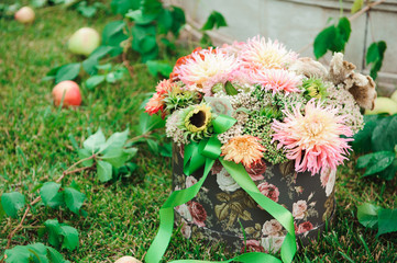 wedding decorations, flowers in a basket and apples on the grass