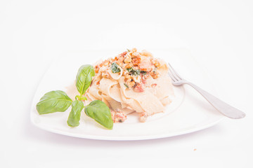 Pasta with cream sauce with bacon, mushrooms, walnuts, spinach