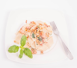 Pasta with cream sauce with bacon, mushrooms, walnuts, spinach