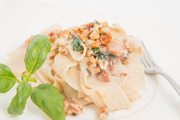Pasta with cream sauce with bacon, mushrooms, walnuts, spinach