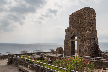 Fototapeta na wymiar Ruins of the Norman castle in Aci Castello, Sicily island, Italy
