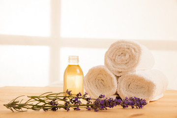 Towels lavender and masage oil on a table in spa salon