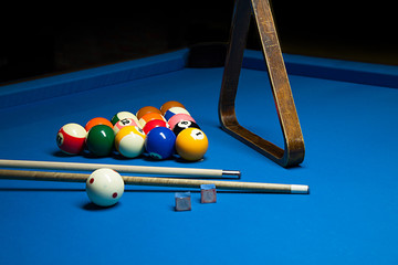 Photo fragment of the blue pool billiard game with cue. Pool bil