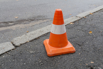 Striped orange cones on the asphalt road