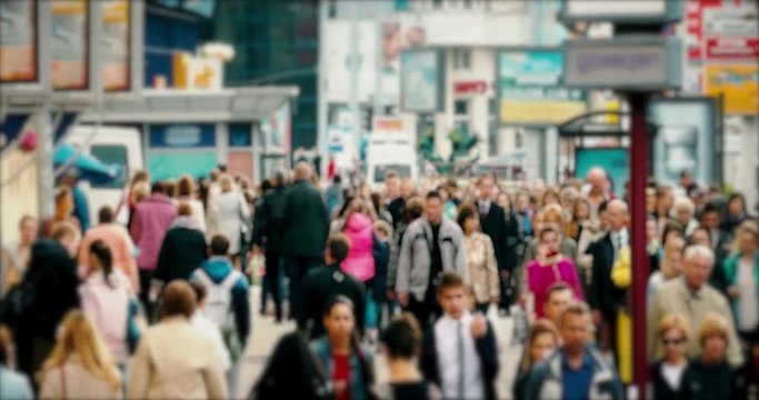 Crowd of People / Commuters Walking / Busy Street. Crowd on a busy street. People walk down a busy street with advertising, billboards, cars and public transport. Slow motion.