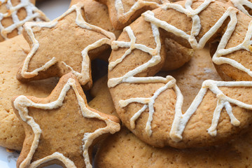 Ginger cookies with Christmas ornaments on the wooden background.