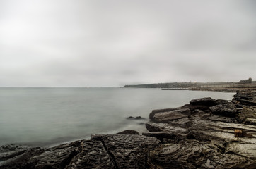 coastal scene, seascape, cloudy sky. Beautiful seascape. Sea and rock at the sunset in winter time. Caspian Sea, Absheron, Azerbaijan