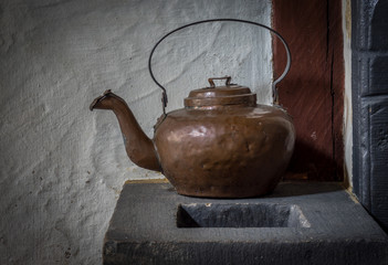 The old and ancient kettle on a stove