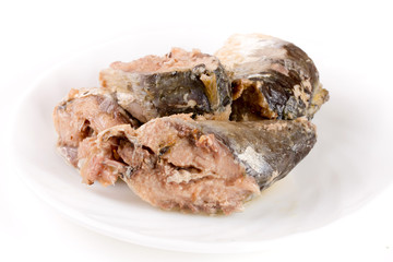 Canned pilchard fish on a plate isolated  white background