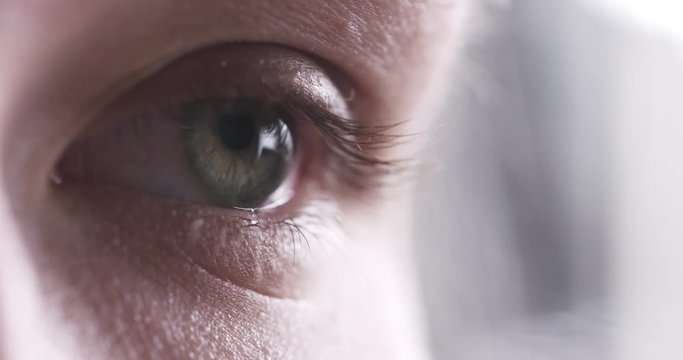 Closeup slow motion of teenage girl eye without makeup looking or watching something, 4k 60fps prores footage
