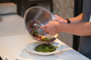 Male hands make salad
