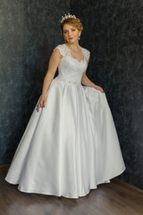 Fototapeta na wymiar Bride in wedding dress on a black background