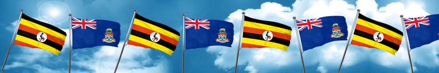 Uganda flag with Cayman islands flag, 3D rendering