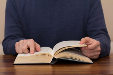 closeup of man hands reading book