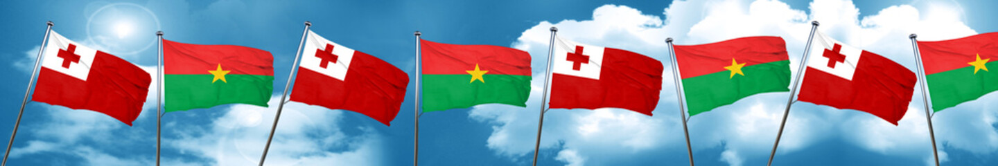 Tonga flag with Burkina Faso flag, 3D rendering