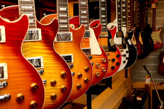 a large number of electric guitars on the counter in the store