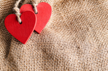 Couple of decorative wooden red hearts for Valentine's day on canvas background