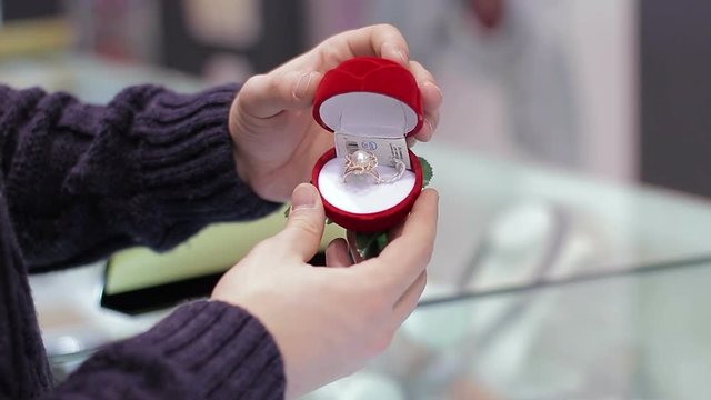 A young man buys a wedding ring for the bride