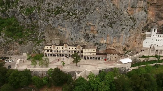 Monastery of Ostrog is a monastery of the Serbian Orthodox Church situated in the large rock of Ostroska Greda. Montenegro. Aerial view
