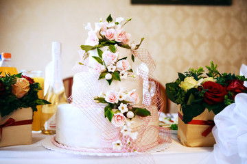 White wedding cake with flowers. The concept of party