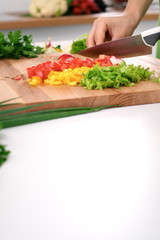 Close up of  woman's hands cooking in the kitchen. Housewife slicing ​​fresh salad. Vegetarian and healthily cooking concept