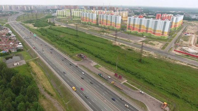 Newly constructed dwelling district with multistory color buildings is near the city ring way at the north of St. Petersburg, Russia. Aerial view
