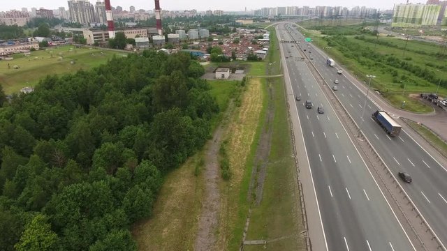 Urban circular highway with parking pocket at the north of St. Petersburg city, Russia. Aerial view from drone
