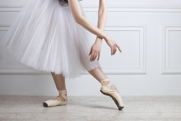 Closeup ballet dancer's legs in pointes and hands