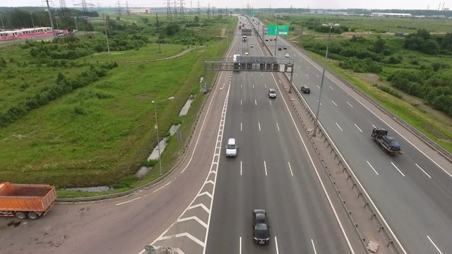 Road traffic at the urban ring road. Vehicles driving highway. Flying across route. St. Petersburg, Russia
