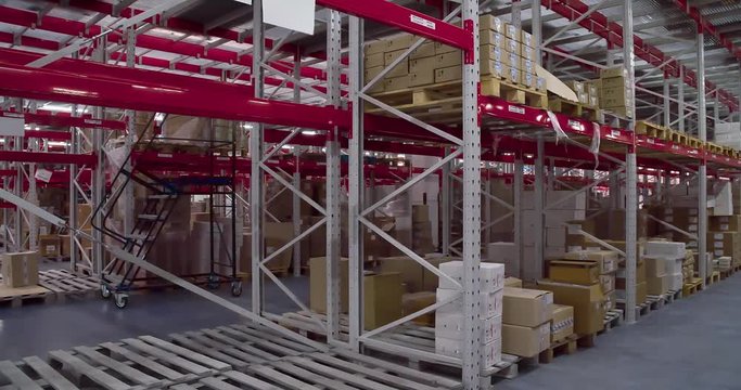 Panorama of shelves with cardboard boxes in storage warehouse 4k video. Logistics stock interior