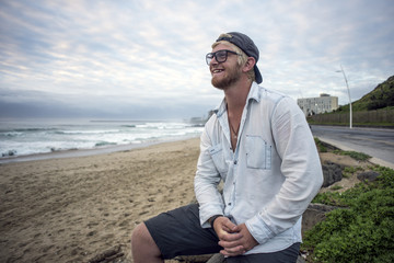 Young man on beach smiling