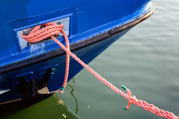 Fishing boat anchored at port with mooring lines or hawsers in port of Wladyslawowo. Poland.