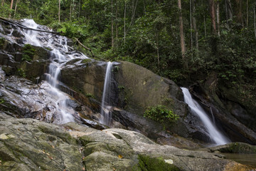Fototapeta na wymiar Amazing scenery of tropical waterfall flowing through the beautiful green forest