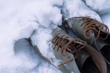 vintage leather shoes covered in snow