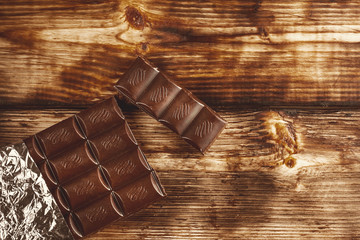 Dark Chocolate bar in foil on gray background
