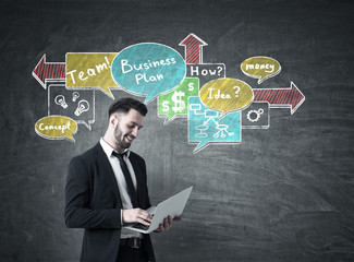 Man with laptop and business scheme