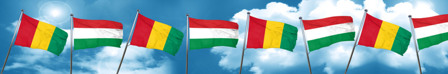 Guinea flag with Hungary flag, 3D rendering